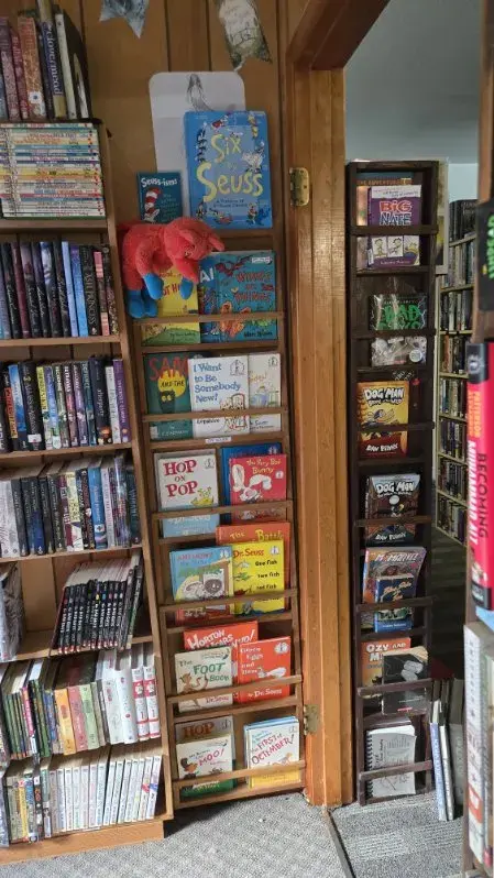 A doorway display rack packed with Dr. Seuss titles and early reader books
